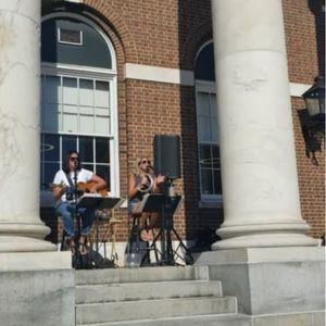 The 2 woman band named Detention perform on the front steps of the Library during Night Market