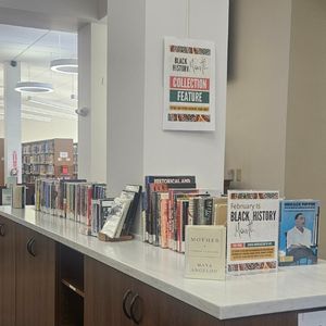 The Library's Black History Month collection feature is set up and displayed on top of the counter where the indoor book drop is located