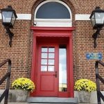 Photo showing the new red front door that was installed at the library in the early 2000s