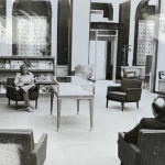 Black and white photograph of the inside of the library in the 1960s and 70s showing patrons reading in arm chairs